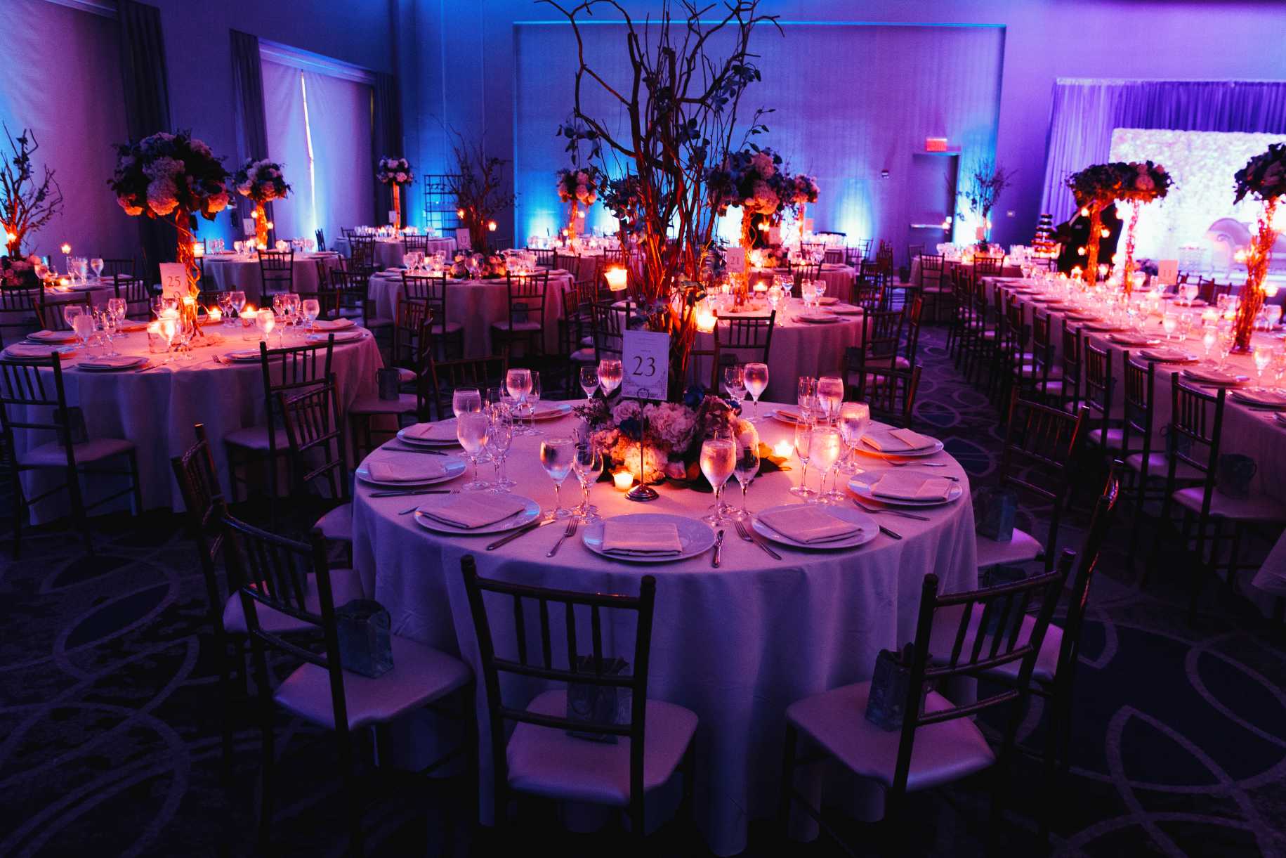 decorated-wedding-hall-with-candles-round-tables-centerpieces (1)
